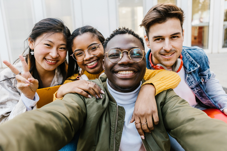 A group of students smiling in a huddle