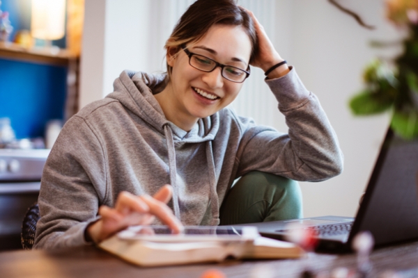 A student using their phone, smiling